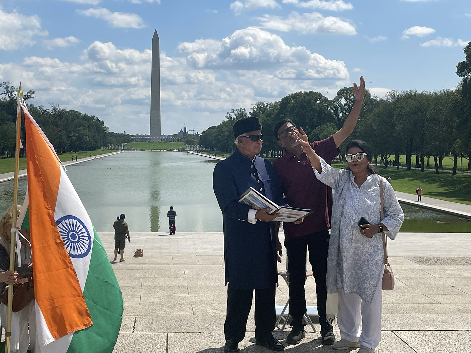 MIke Ghouse, on left holding binder, leads an India Independence Day event on the National Mall in Washington, Sunday, Aug. 13, 2023. RNS photo by Richa Karmarkar