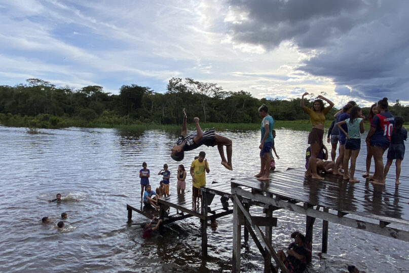 Kids play in Atalaia do Norte, Amazonas state, Brazil, March 1, 2023. Scores of Indigenous families have left their territory in the Javari Valley for the impoverished city of Atalaia do Norte. (AP Photo/Fabiano Maisonnave, File)