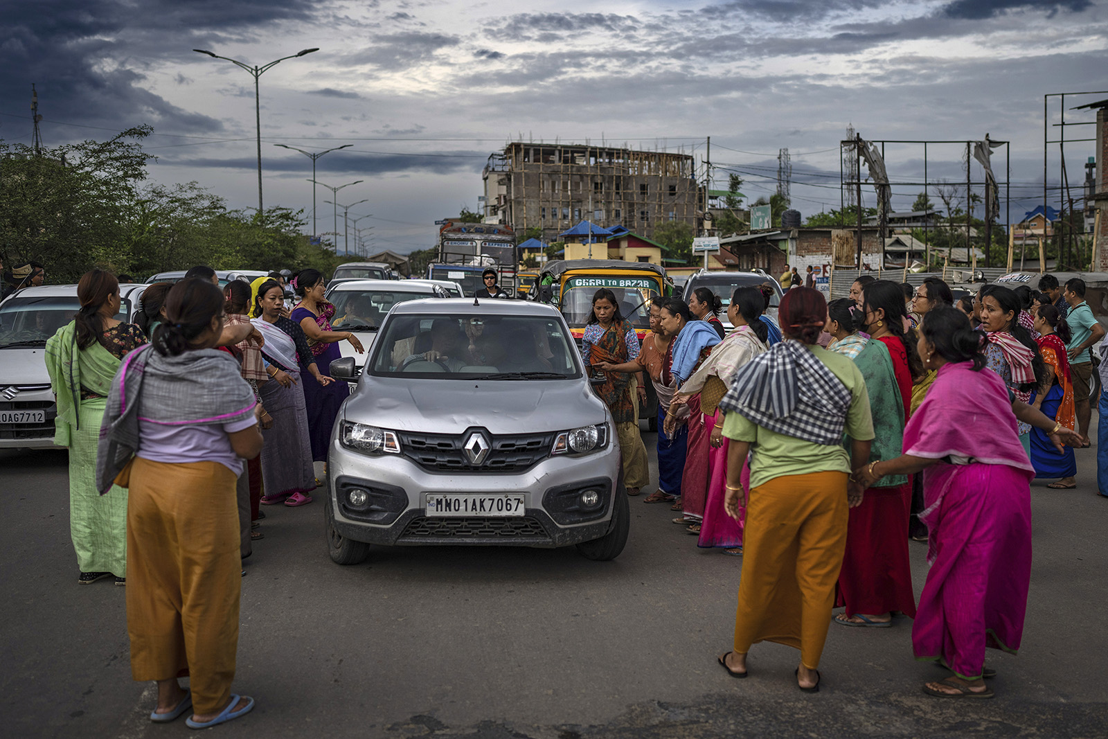 FILE- Members of Meira Paibis, a powerful vigilante group of Hindu majority Meitei women, block traffic as they check vehicles for the presence of members from the rival Christian tribal Kuki community, in Imphal, capital of the northeastern Indian state of Manipur, June 19, 2023. For three months, Indian Prime Minister Narendra Modi has been largely silent on ethnic violence that has killed over 150 people in Manipur. That's sparked a no-confidence motion against his government in Parliament, where his party and allies hold a clear majority. (AP Photo/Altaf Qadri, File)