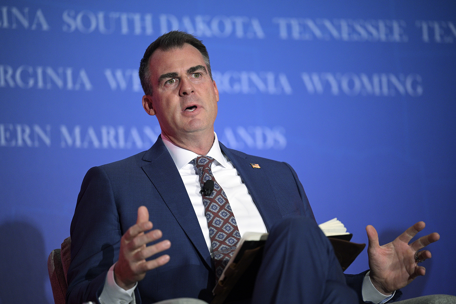 FILE - Oklahoma Gov. Kevin Stitt answers a question while taking part in a panel discussion during a Republican Governors Association conference, Wednesday, Nov. 16, 2022, in Orlando, Fla. On Monday, July 31, 2023, a group of parents, faith leaders and a public education nonprofit sued to stop Oklahoma from establishing and funding what would be the nation’s first religious public charter school. (AP Photo/Phelan M. Ebenhack, File)