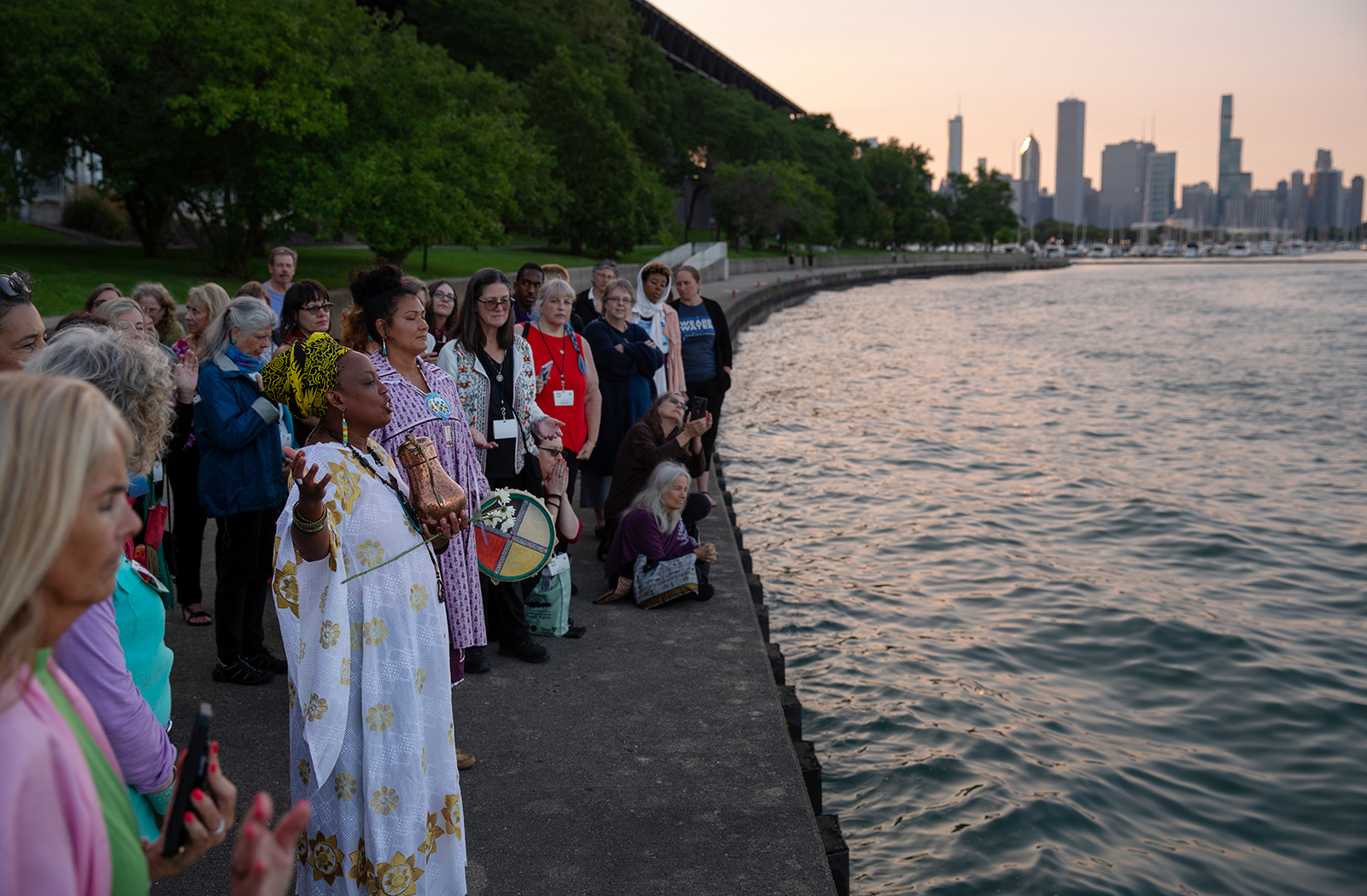 Yoruba priestess Aina-Nia leads a water ceremony by Lake Michigan as part of the Parliament of the World's Religions in Chicago on August 15, 2023. During the ceremony, which recognized the sacredness of water, water from different parts of the world was combined and poured into the lake. Photo by Lauren Pond for RNS