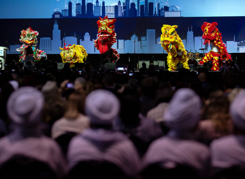 Attendees watch a performance by the Tai Ji Men community during the opening ceremony of the Parliament of the World’s Religions in Chicago, Aug. 14, 2023. Photo by Lauren Pond for RNS