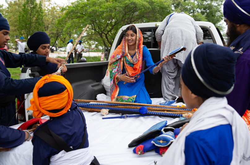 Jasmeen Kaur and other members of the Sikh Religious Society of Palatine prepare to participate in the Parade of Faiths in downtown Chicago on Aug. 13, 2023. The parade preceded the Parliament of the World's Religions, which began Aug. 14. Photo by Lauren Pond for RNS