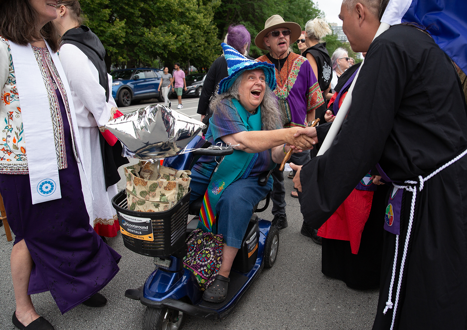 The Rev. Selena Fox of Circle Sanctuary greets another participant in the Parade of Faiths in downtown Chicago on Aug. 13, 2023. The parade preceded the Parliament of the World’s Religions, which began Aug. 14. Photo by Lauren Pond for RNS