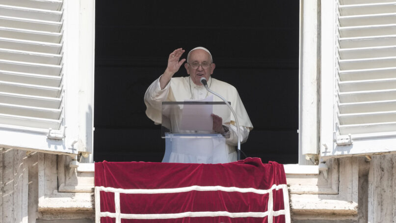 Pope Francis delivers his blessing as he recites the Angelus noon prayer from the window of his studio overlooking St. Peter's Square, at the Vatican, Sunday, Aug. 20, 2023. (AP Photo/Andrew Medichini)