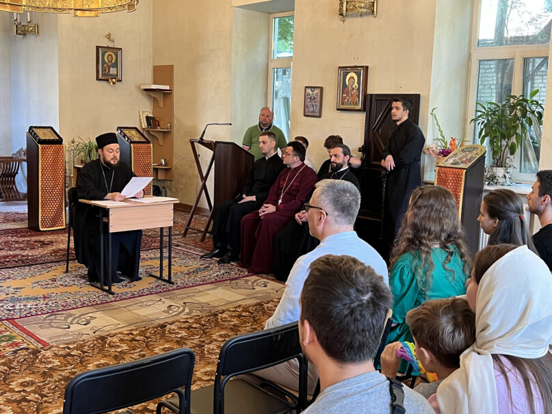 Abbot Job Olshansky, left, speaks at a parish meeting of the Holy Resurrection New Athos Monastery in Lviv, Ukraine, Aug. 13, 2023. Photo by Meagan Saliashvili