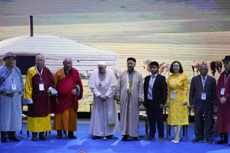 Religious leaders with Pope Francis, fourth from left, pose for a family photo at the end of a meeting at the Hun Theatre in the Sky Resort compound some 15 kilometers south of the Mongolian capital Ulaanbaatar, Sunday, Sept. 3, 2023. Pope Francis has praised Mongolia's tradition of religious freedom dating to the times of founder Genghis Khan during the first-ever papal visit to the Asian nation. (AP Photo/Andrew Medichini)