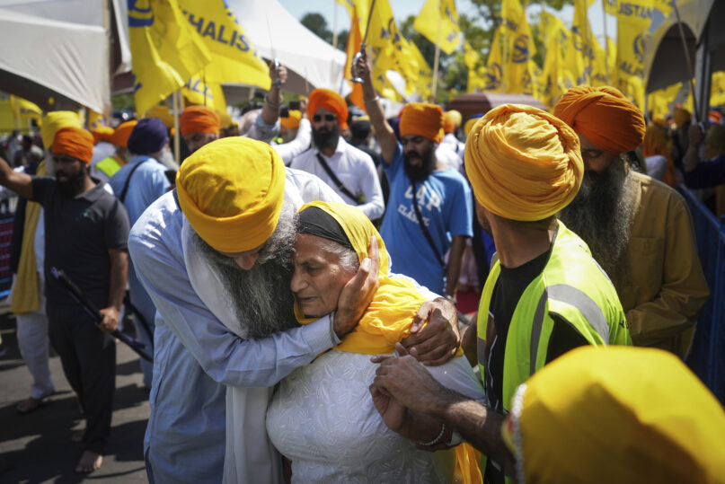 A woman is consoled as people mourn Sikh community leader and temple president Hardeep Singh Nijjar during Antim Darshan, the first part of daylong funeral services for him, in Surrey, British Columbia, June 25, 2023. Nijjar was gunned down in his vehicle while leaving the Guru Nanak Sikh Gurdwara Sahib parking lot. The September 2023 accusation by Canadian Prime Minister Justin Trudeau that India may have been behind the assassination of Nijjar, a Sikh separatist leader, has raised several complex questions about the nature of Sikh activism in the North American diaspora. (Darryl Dyck/The Canadian Press via AP, File)