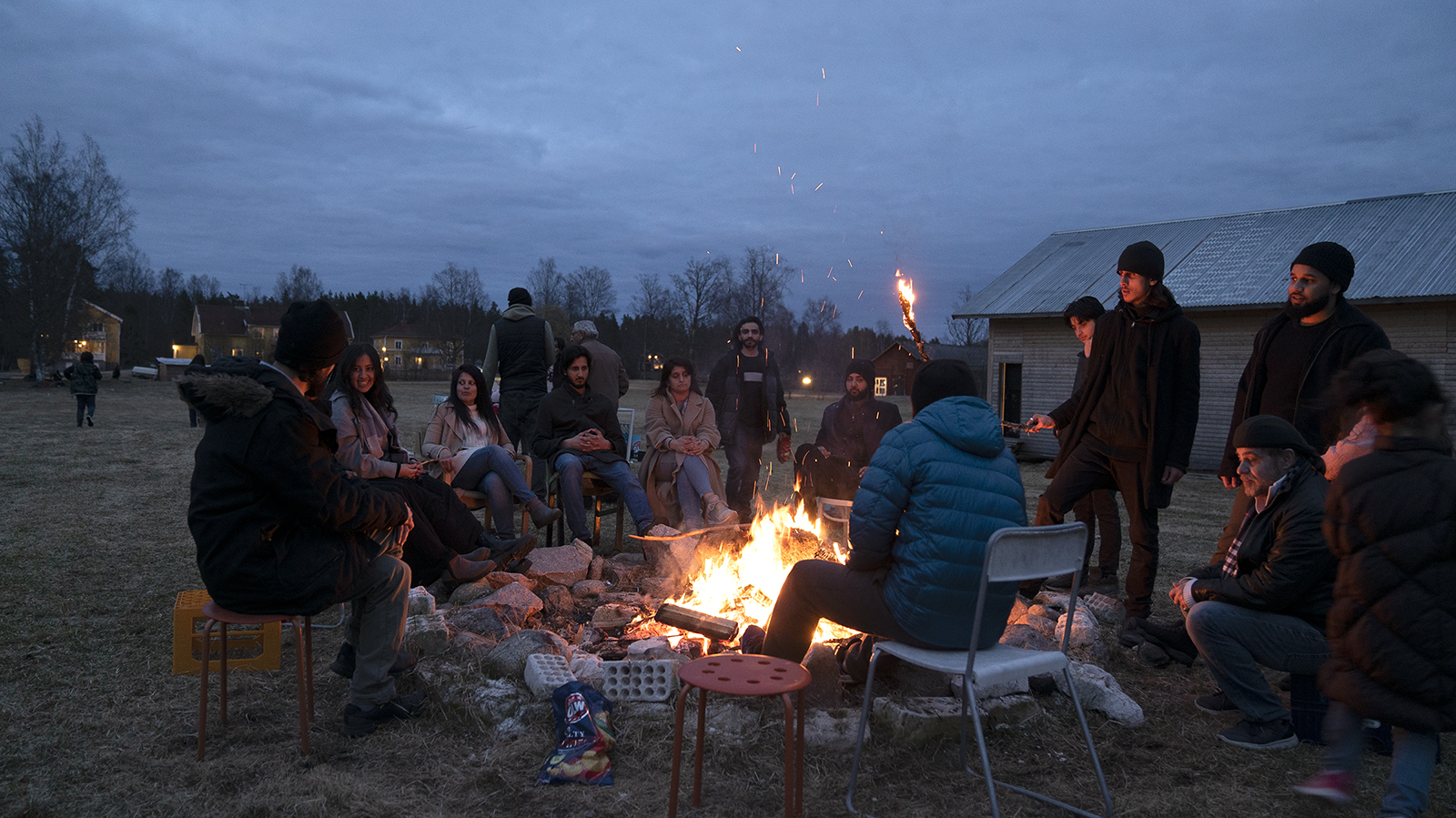 Members of the Ahmadi Religion of Peace and Light community mingle around a bonfire. Photo courtesy Hadil El-Khouly
