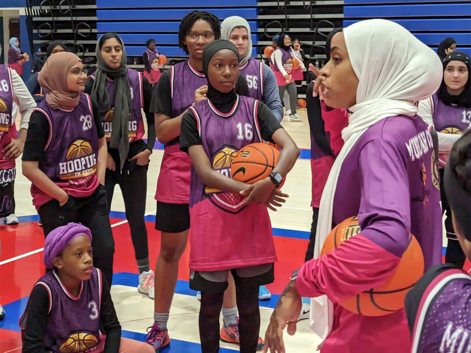 Bilqis Abdul-Qaadir, right, talks to players during a Hooping in Faith basketball program in July 2023 in Memphis, Tenn. Photo by Fathima Darboe