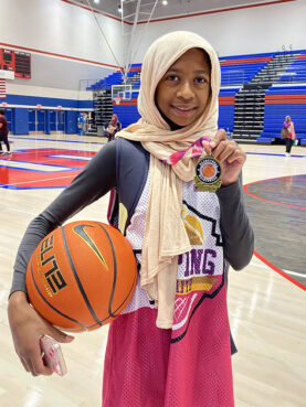 Niya M. poses with a medal at a Hooping in Faith event in July 2023 in Memphis, Tenn. Photo by Liz Kineke