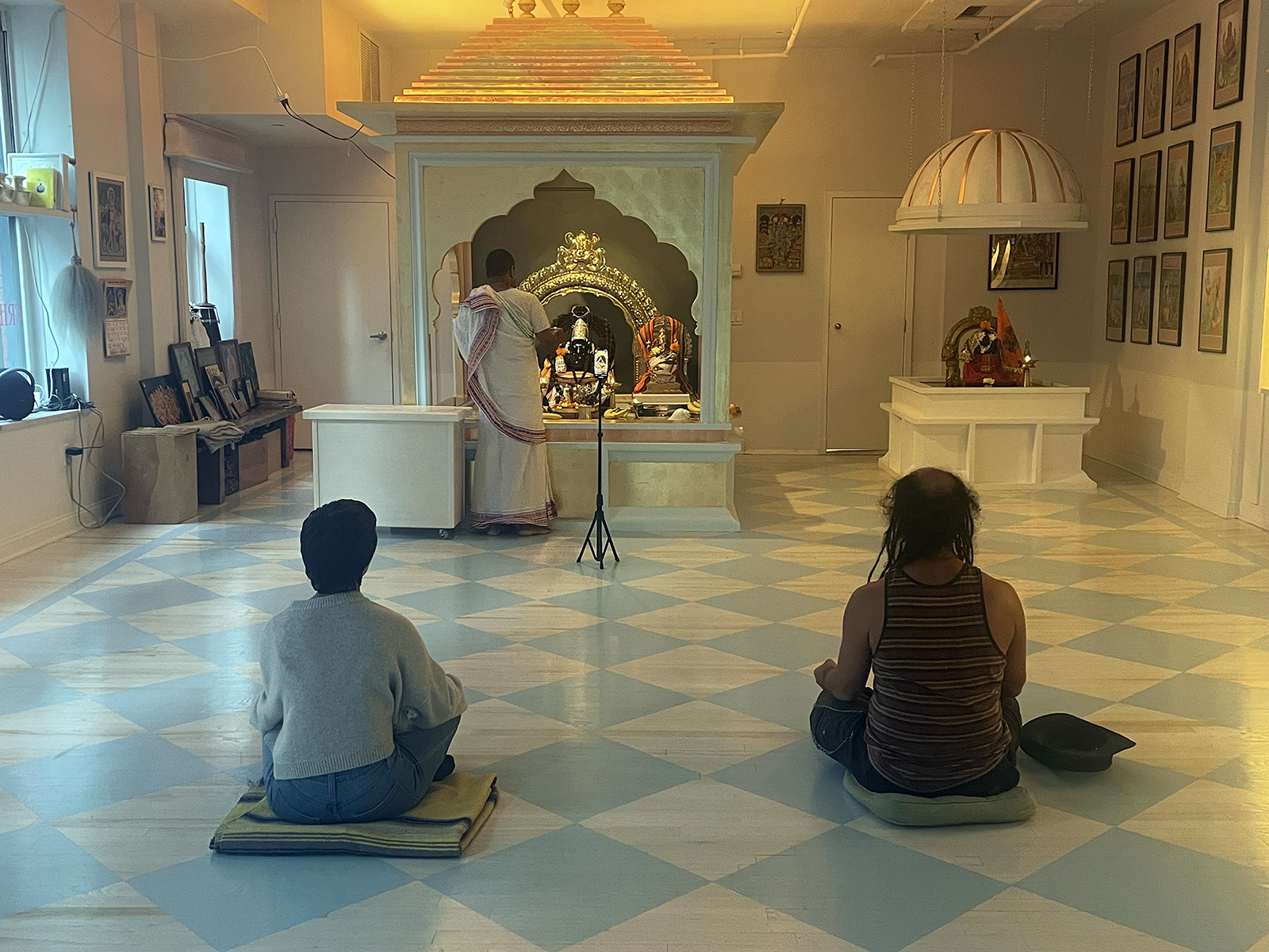 Priest Prakash livestreams the Lord Shiva puja, which occurs every Thursday, at Broome Street Ganesha Temple in Manhattan, Sept. 14, 2023. RNS photo by Richa Karmarkar