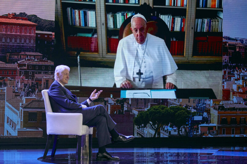 Former President Bill Clinton, left, speaks with Pope Francis, on screen, via video during the Clinton Global Initiative, Monday, Sept. 18, 2023 in New York. (AP Photo/Andres Kudacki)