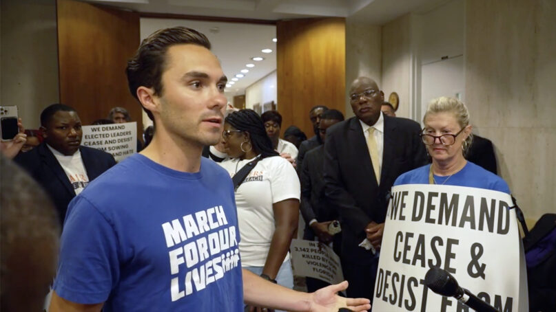 David Hogg speaks to supporters and media after a coalition of organizations delivered a 
