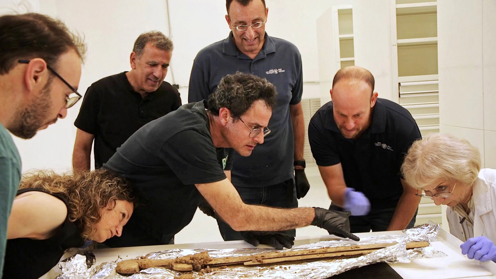 Israel Antiquities Authority researchers examine one of the swords recently discovered near the Dead Sea. Photo by Emil Aladjem, Israel Antiquities Authority