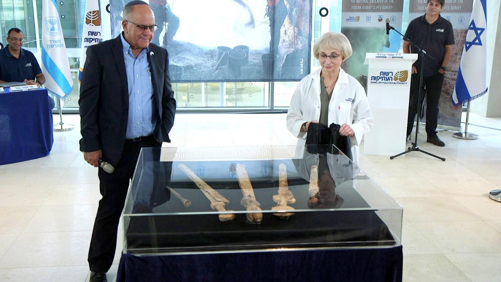 Eli Escusido, Director of the Israel Antiquities Authority, left, and conservator Lena Kupershmidt present the swords at a press conference on Sept. 6, 2023. Photo by Israel Antiquities Authority