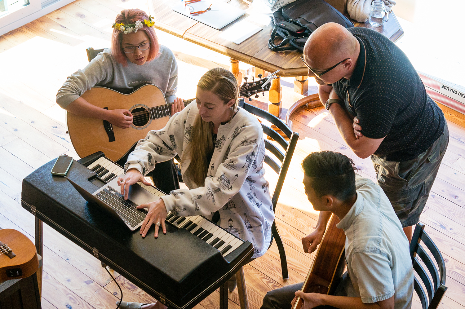 Daniel Whitehead, Valerie Guerra, Niki Jung and Paul Lee huddle together around a keyboard during a day of the retreat. The group of Sanctuary staff joined with songwriters to spend the full five days collaborating and creating the album. Photo courtesy The Porter’s Gate