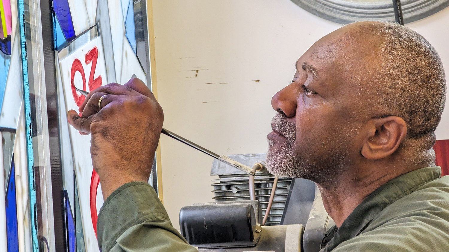 Kerry James Marshall paints the letters of one of the signs included in the new stained glass window. Photo courtesy of Washington National Cathedral