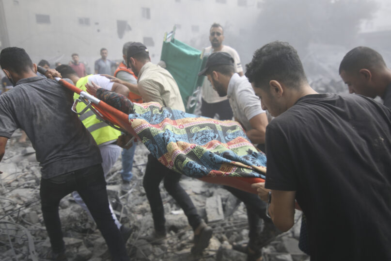 Palestinians evacuate wounded after an Israeli airstrike in Rafah refugee camp, southern Gaza Strip, Thursday, Oct. 12, 2023. (AP Photo/Hatem Ali)