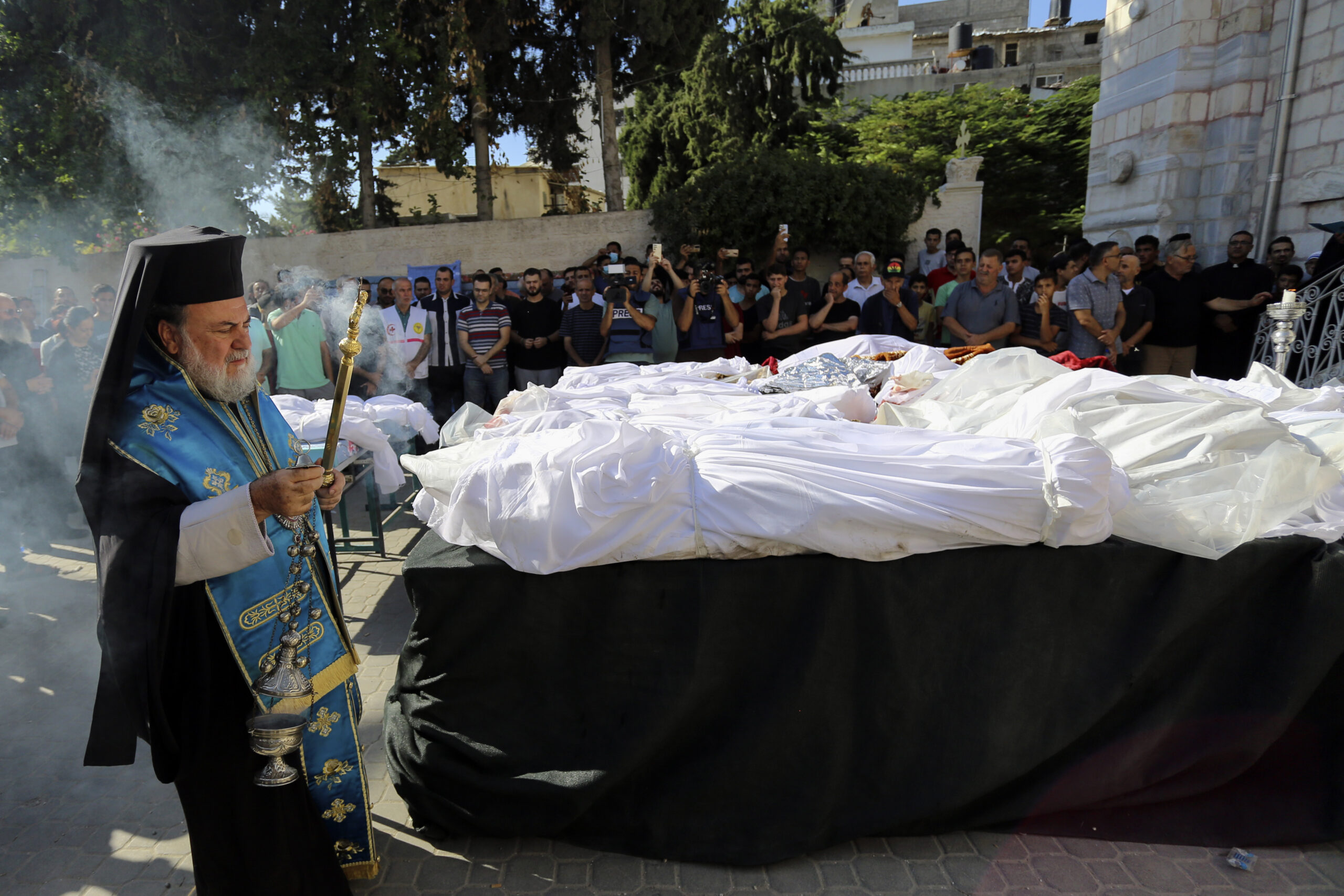 Greek Orthodox Archbishop Alexios holds a funeral prayer for Palestinians who were killed in Israeli airstrikes that hit a Greek Orthodox church, in Gaza City, Friday, Oct. 20, 2023. (AP Photo/Abed Khaled)