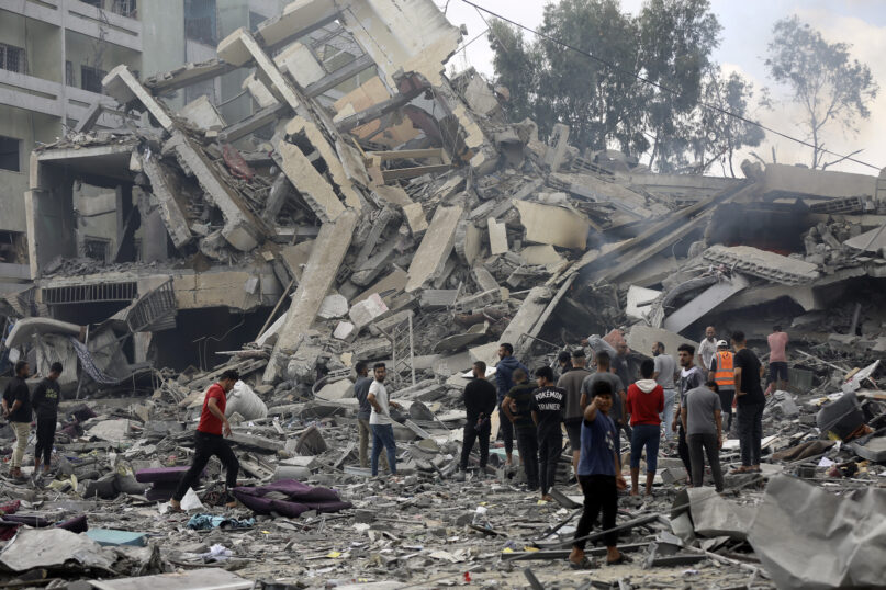 Palestinians inspect the damage of a destroyed building following Israeli airstrikes on Gaza City, Thursday, Oct. 19, 2023. (AP Photo/Abed Khaled)