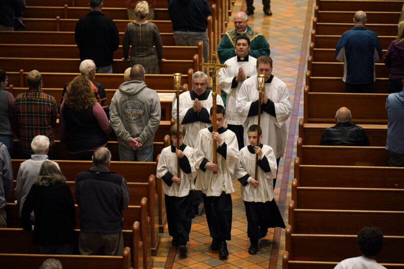 Altar boys and priests walk down the center aisle at the conclusion of mass at the Basilica of Saints Peter and Paul on Oct. 29, 2023, in Lewiston, Maine. | Robert F. Bukaty/AP