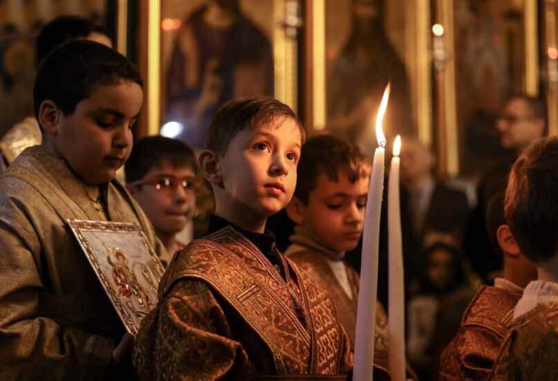 Children at an Orthodox Christmas Mass at the Church of Saint Porphyrius in Gaza City on Jan. 7, 2023.  (Mahmud Hams/AFP via Getty Images)