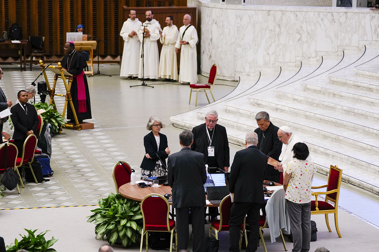 From left foreground front to camera, Sister Nathalie Becquart, Synod of Bishop's Rapporteur Cardinal Jean-Claude Hollerich, Synod of Bishops' Secretary General Cardinal Mario Grech, attend with Pope Francis a session of the 16th general assembly of the synod of bishops in the Paul VI Hall at The Vatican, Monday, Oct. 16, 2023. (AP Photo/Domenico Stinellis)