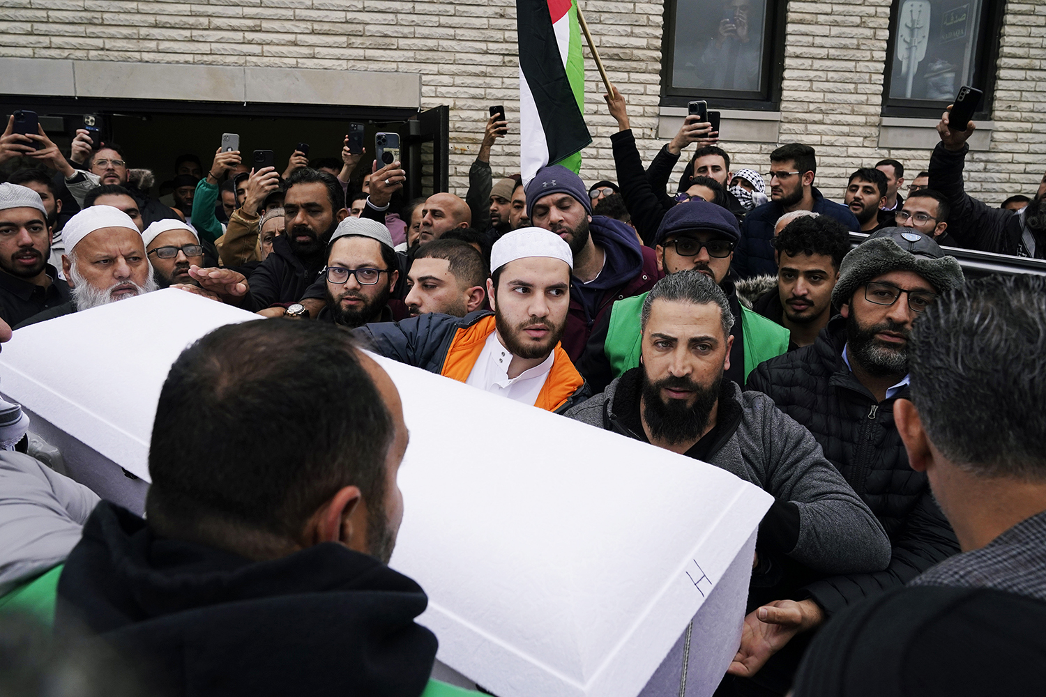 Family members of Wadea Al-Fayoume bring out his casket from the Mosque Foundation to the hearse in Bridgeview, Ill., Oct. 16, 2023. An Illinois landlord accused of fatally stabbing the 6-year-old Muslim boy and seriously wounding his mother was charged with a hate crime after police and relatives said he singled out the victims because of their faith and as a response to the war between Israel and Hamas. (AP Photo/Nam Y. Huh)