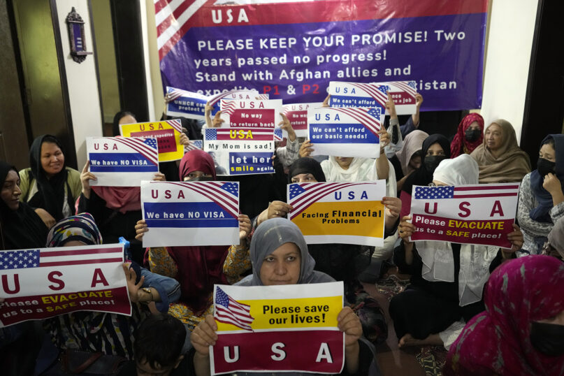 Afghan refugees hold an indoor rally to demand their U.S. visa applications be processed, in Islamabad, Pakistan, July 21, 2023. When the U.S. pulled out of Afghanistan in August 2021, it carried tens of thousands of Afghans to safety. But two years later, many others are still waiting to be resettled. Those are Afghans who helped the war effort by working with the U.S. government and military or Afghan journalists and aid workers whose former work puts them at risk under the Taliban. (AP Photo/Rahmat Gul)