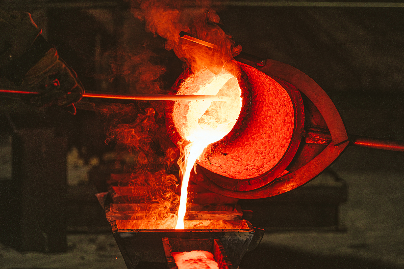 Molten bronze produced by melting Charlottesville's monument of Robert E. Lee is poured from a hot crucible into ingot molds, Oct. 21, 2023. Photo © Eze Amos