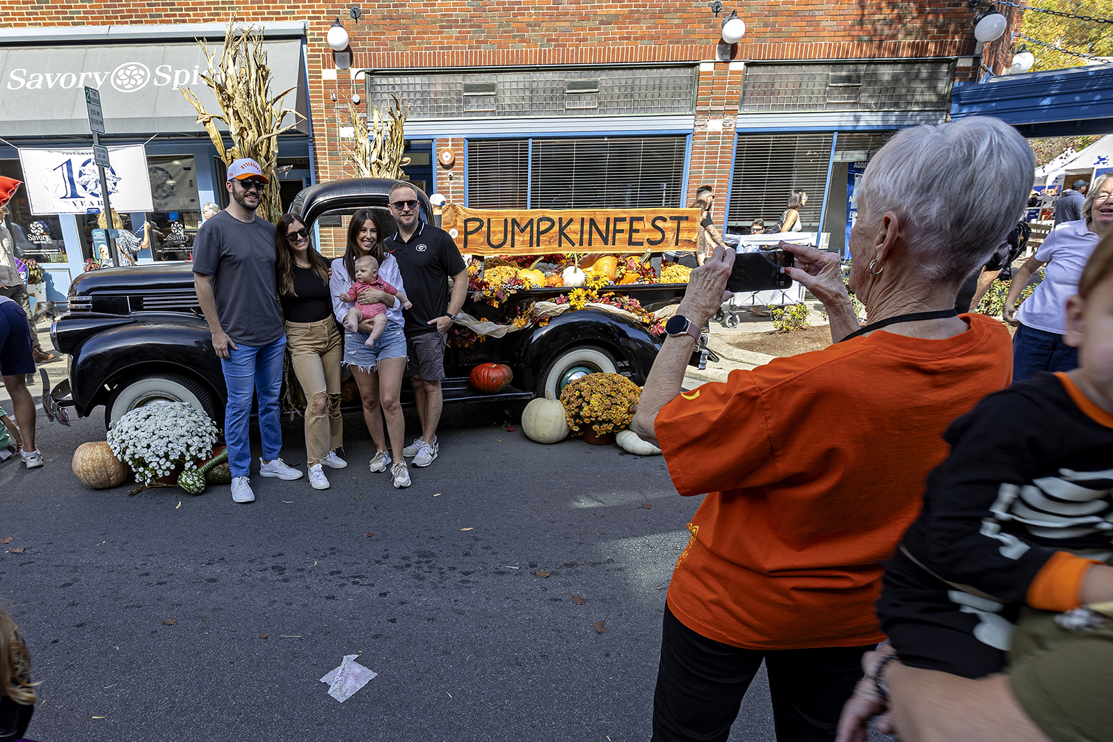 People take photos next to an antique truck during Pumpkinfest, Saturday, Oct. 28, 2023, in Franklin, TN. (RNS photo/Wade Payne)
