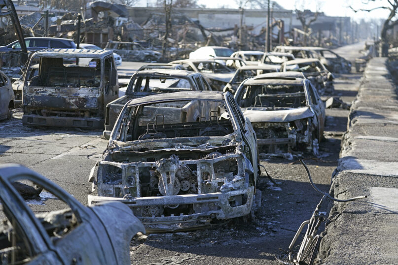 Burned-out cars line the sea walk after the wildfire on Aug. 11, 2023, in Lahaina, Hawaii. (AP Photo/Rick Bowmer)