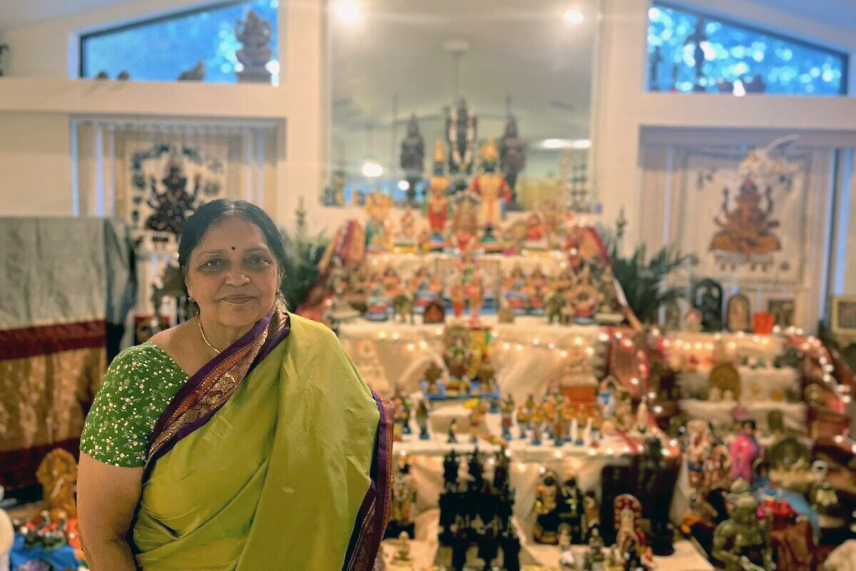 Vasudha Narayanan poses in front of her golu, a tiered Hindu altar. Photo courtesy Vasudha Narayanan