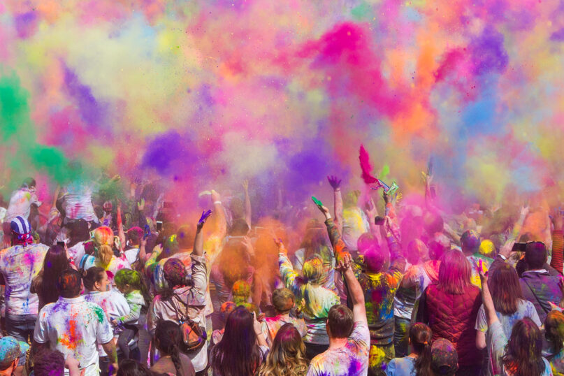 Colors are thrown in the air during a Holi festival in Spanish Fork, Utah. Photo by Photo by John Thomas/Unsplash/Creative Commons