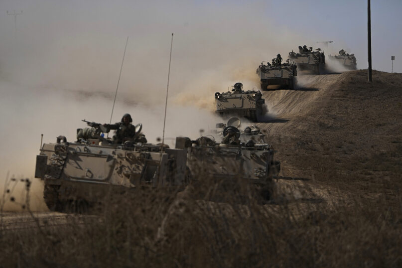 Israeli tanks head toward the Gaza Strip border in southern Israel on Oct. 13, 2023. (AP Photo/Ariel Schalit)