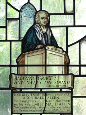 An image of John Newton in a stained-glass window at St. Peter and St. Paul Church in Olney, England. Photo by Adam Jones/Wikimedia/Creative Commons