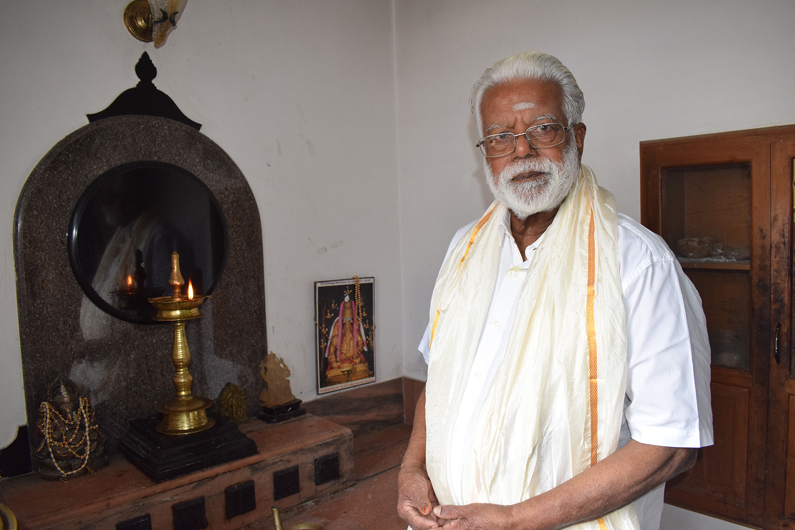 Govindan Gopalakrishnan poses in the interfaith space in his home in Trivandrum, Kerala, India, Oct. 8, 2023. (RNS photo/Priyadarshini Sen)