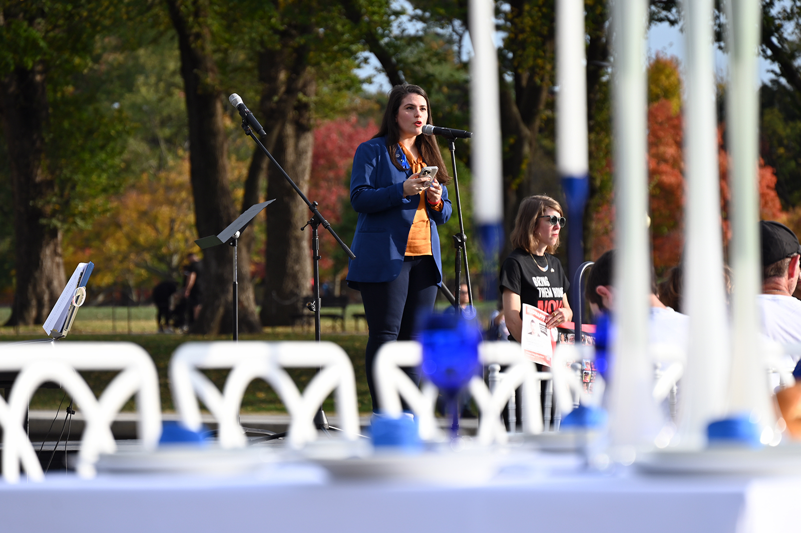 Sheila Katz, CEO of the National Council of Jewish Women, speaks before an Shabbat table, with empty chairs representing hostages taken by Hamas, at the Lincoln Memorial, Friday, Oct. 27, 2023, in Washington. (RNS photo/Jack Jenkins)