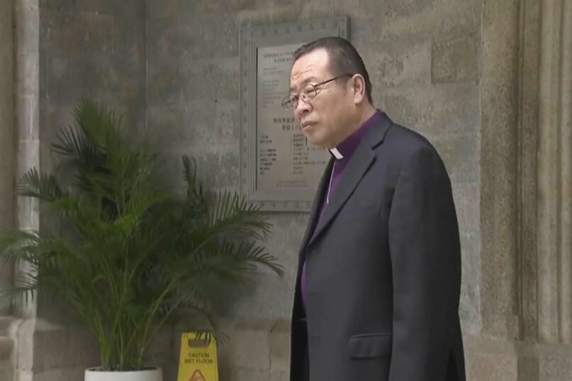 In this image taken from a video footage run by TVB, Joseph Li, the head of the Catholic church in China, stands outside Hong Kong's Cathedral of the Immaculate Conception in Hong Kong on Tuesday, Nov. 14, 2023. Li took a trip to Hong Kong at the invitation of the city's pope-appointed Roman Catholic cardinal, marking the first official visit by a Beijing bishop in history. (TVB via AP)