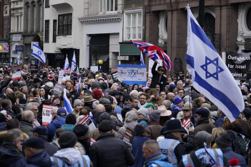 Protesters holding placards flags and banners, including the flag of Israel, during an anti-Semitism demonstration in London, Sunday, Nov. 26, 2023. (AP Photo/Alberto Pezzali)