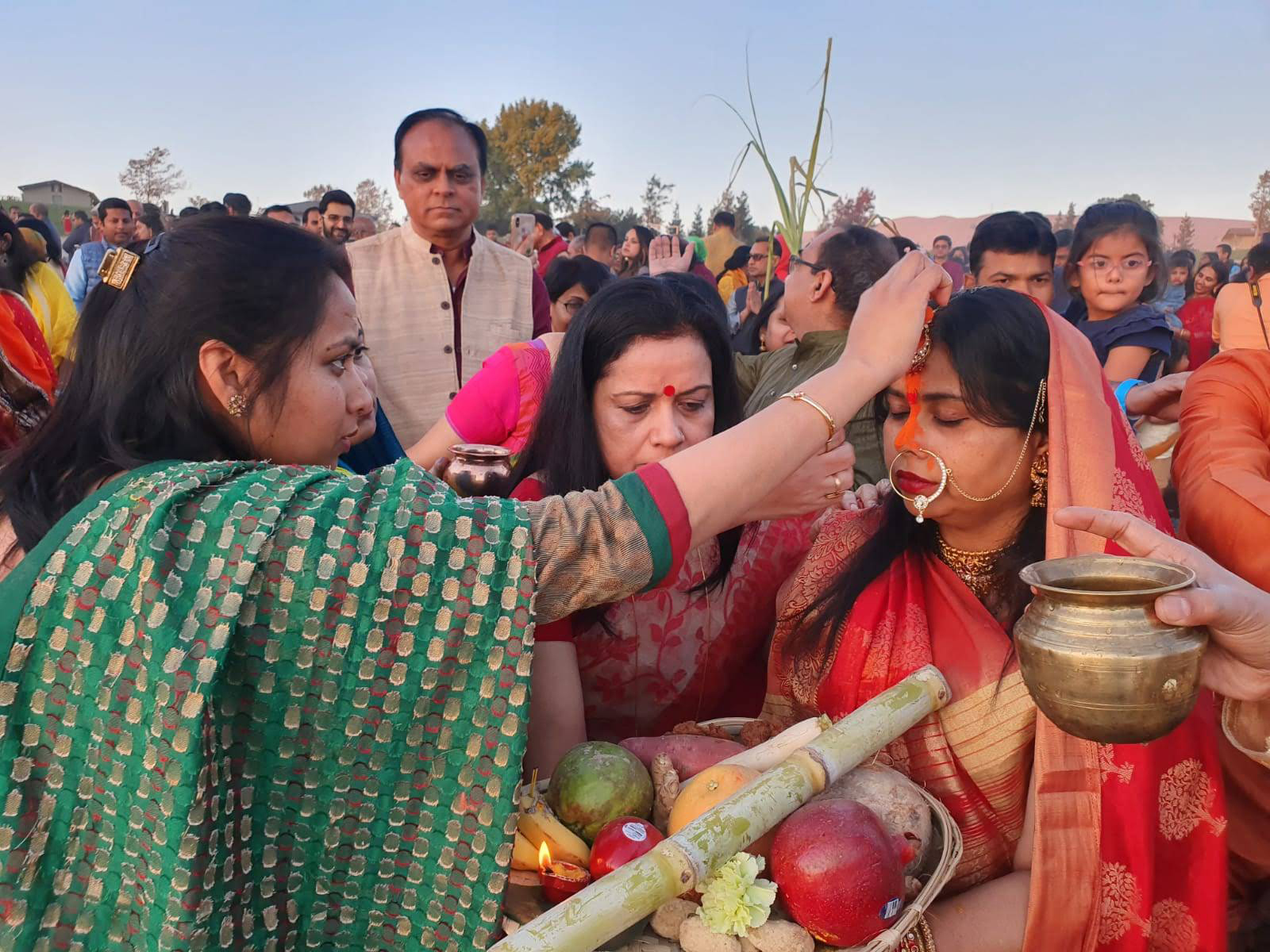 Manisha Pathak, right, prepares to offer Chhath puja prayers at Quarry Lakes Regional Recreation Area in Fremont, California, in Nov. 2019. (Photo courtesy Sunil and Shalini Singh)