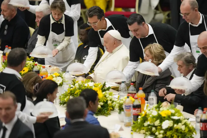 Pope Francis sits at a table during a lunch, in the Paul VI Hall at the Vatican, Sunday, Nov. 19, 2023. Pope Francis offered several hundred poor people, homeless, migrants, unemployed a lunch on Sunday as he celebrates the World Day of the Poor with a concrete gesture of charity in the spirit of his namesake, St. Francis of Assisi. (AP Photo/Andrew Medichini)