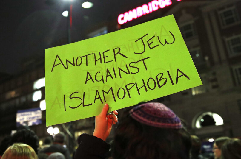 FILE - A sign is held up during a protest by several hundred people organized by the Harvard Islamic Society near the campus of Harvard University in Cambridge, Mass., March 7, 2017.   The Biden administration is warning U.S. schools and colleges that they must take immediate action to stop antisemitism and Islamophobia on their campuses, citing an “alarming rise” in threats and harassment. (AP Photo/Charles Krupa, File)