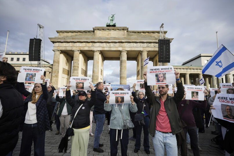 Demonstrators display posters of people reported missing or held by Hamas as hostages, during a demonstration against antisemitism and to show solidarity with Israel, in front of the Brandenburg Gate in Berlin, Oct. 22, 2023. (AP Photo/Markus Schreiber)