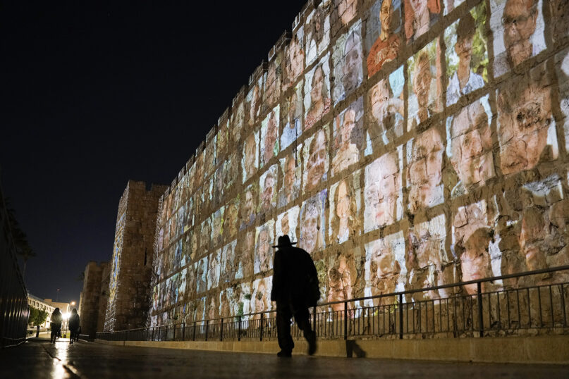 Photographs of Israeli hostages being held by Hamas militants are projected on the walls of Jerusalem’s Old City, Nov. 6, 2023. The Islamic militant group killed 1,400 people and kidnapped 240 others in an unprecedented cross-border attack on Oct. 7, triggering a war that has raged for the past month. (AP Photo/Leo Correa)