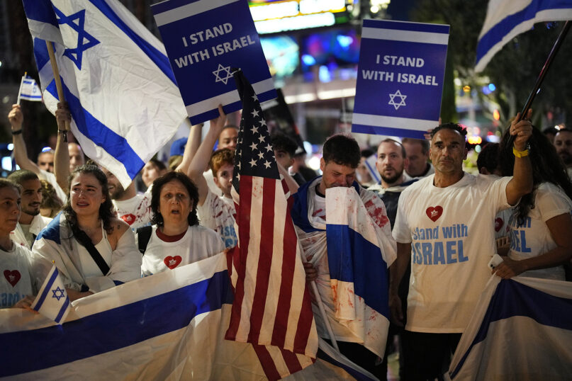 People hold flags and banners during a rally in support of Israel, Sunday, Oct. 8, 2023, in Las Vegas. (AP Photo/John Locher)