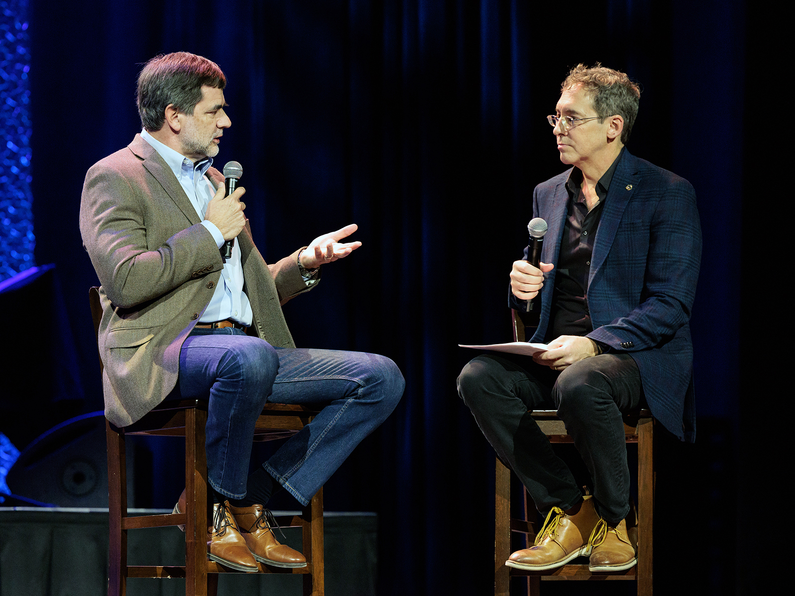 Lee C. Camp, right, interviews Dr. Curt Thompson during a live “No Small Endeavor" Thanksgiving show at Ryman Auditorium, Nov. 20, 2022, in Nashville. (Photo by Eric Brown)