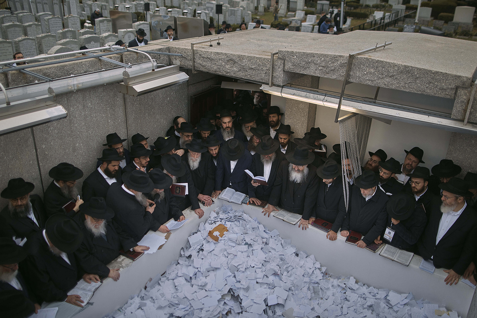 Chabad-Lubavitch rabbis pray at the resting place of the Rebbe, Rabbi Menachem Mendel Schneerson, at Montefiore Cemetery on Friday, Nov. 10, 2023, in the Queens borough of New York. This year's conference focuses on the war between Israel and Hamas, antisemitism on college campuses and Jewish spiritual awakening following the attacks of Oct. 7. (AP Photo/Andres Kudacki)