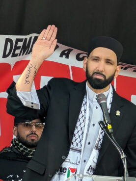 Imam Omar Suleiman displays his name written on his arm while speaking at a pro-Palestinian demonstration in Washington on Saturday, Nov. 4, 2023. (Courtesy photo)